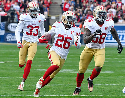Dec 24, 2016; Los Angeles, CA, USA; San Francisco 49ers cornerback Tramaine Brock (center) runs upfield with a first quarter interception followed by cornerback Rashard Robinson (33) and outside linebacker Eli Harold (58) on a pass intended for Los Angeles Rams wide receiver Tavon Austin (not pictured) at Los Angeles Memorial Coliseum. Mandatory Credit: Robert Hanashiro-USA TODAY Sports