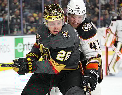 Dec 31, 2021; Las Vegas, Nevada, USA; Anaheim Ducks defenseman Hampus Lindholm (47) tips the puck away from Vegas Golden Knights center Mattias Janmark (26) during the second period at T-Mobile Arena. Mandatory Credit: Stephen R. Sylvanie-USA TODAY Sports