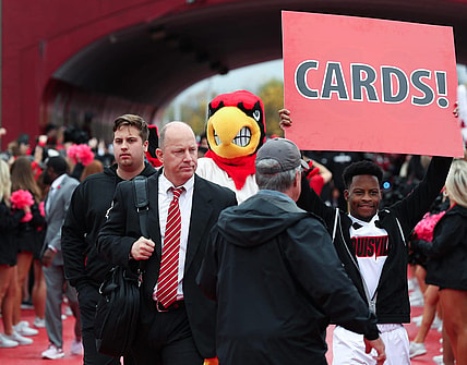 U of L head football coach Jeff Brohm enters the stadium during the Cards March ahead of their game against Duke at the L&N Stadium in Louisville, Ky. on Oct. 28, 2023.