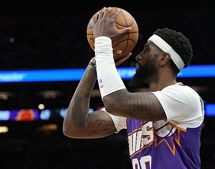 Mar 21, 2024; Phoenix, Arizona, USA; Phoenix Suns forward Royce O'Neale (00) shoots against the Atlanta Hawks during the first half at Footprint Center. Mandatory Credit: Joe Camporeale-USA TODAY Sports