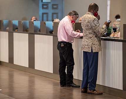 Sep 4, 2020; Louisville, Kentucky, USA; Two men bet on the second floor of Churchill Downs on Kentucky Oaks day.  Mandatory Credit: Pat McDonogh/Louisville Courier-Journal-USA TODAY NETWORK