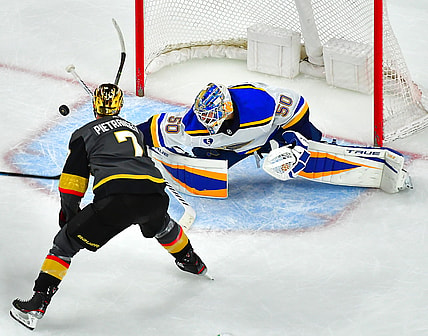 May 7, 2021; Las Vegas, Nevada, USA; St. Louis Blues goaltender Jordan Binnington (50) deflects the puck away from Vegas Golden Knights defenseman Alex Pietrangelo (7) during an overtime period at T-Mobile Arena. Mandatory Credit: Stephen R. Sylvanie-USA TODAY Sports