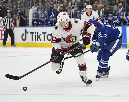 Oct 16, 2021; Toronto, Ontario, CAN; Ottawa Senators forward Shane Pinto (12) picks up a rebound against the Toronto Maple Leafs during the second period at Scotiabank Arena. Mandatory Credit: John E. Sokolowski-USA TODAY Sports