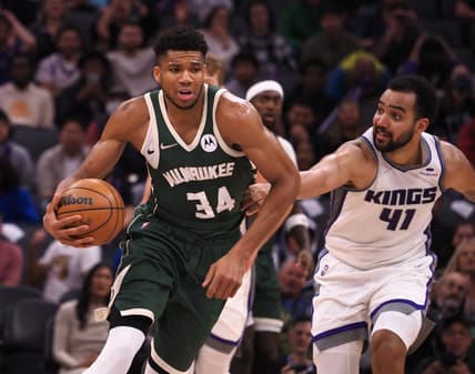 Mar 16, 2022; Sacramento, California, USA; Sacramento Kings forward Trey Lyles (41) fouls Milwaukee Bucks forward Giannis Antetokounmpo (34) on a fast break during the fourth quarter at Golden 1 Center. Mandatory Credit: Kelley L Cox-USA TODAY Sports