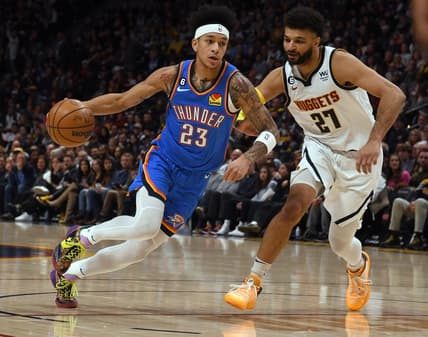 Jan 22, 2023; Denver, Colorado, USA; Oklahoma City Thunder guard Tre Mann (23) drives on Denver Nuggets guard Jamal Murray (27) during the first quarter at Ball Arena. Mandatory Credit: John Leyba-USA TODAY Sports