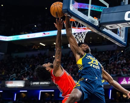 Jan 24, 2023; Indianapolis, Indiana, USA; Indiana Pacers forward Aaron Nesmith (23) blocks the shot of Chicago Bulls guard Coby White (0) in the second half at Gainbridge Fieldhouse. Mandatory Credit: Trevor Ruszkowski-USA TODAY Sports