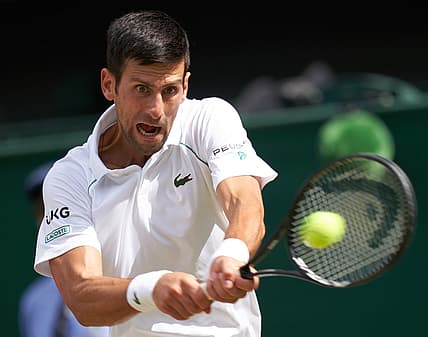 Jul 11, 2021; London, United Kingdom; Novak Djokovic (SRB) hits the ball against Matteo Berrettini (ITA) in the men s final  on Centre Court at All England Lawn Tennis and Croquet Club. Mandatory Credit: Peter van den Berg-USA TODAY Sports