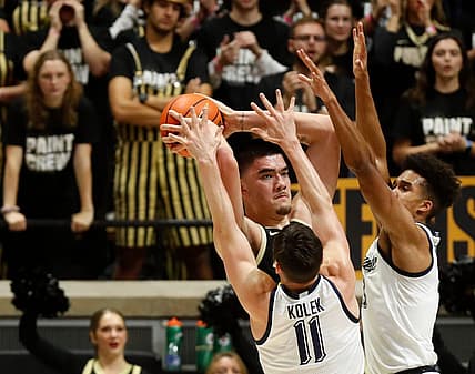 Purdue Boilermakers center Zach Edey (15) is guarded by Marquette Golden Eagles guard Tyler Kolek (11) and Marquette Golden Eagles forward Oso Ighodaro (13) during the NCAA men   s basketball game, Tuesday, Nov. 15, 2022, at Mackey Arena in West Lafayette, Ind. Purdue won 75-70.

Purduemarquettembb111522 Am34173