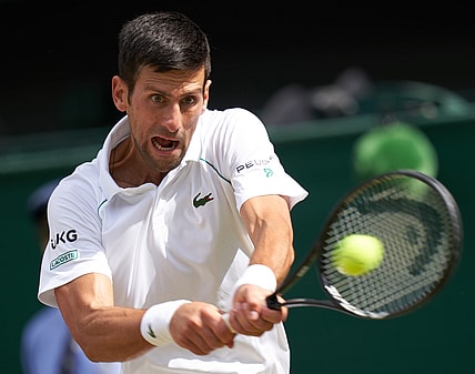 Jul 11, 2021; London, United Kingdom; Novak Djokovic (SRB) hits the ball against Matteo Berrettini (ITA) in the men s final  on Centre Court at All England Lawn Tennis and Croquet Club. Mandatory Credit: Peter van den Berg-USA TODAY Sports