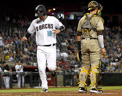 Aug 13, 2021; Phoenix, Arizona, USA; Arizona Diamondbacks catcher Carson Kelly (18) scores a run past  San Diego Padres catcher Austin Nola (26) in the second inning of the game at Chase Field. Mandatory Credit: Jayne Kamin-Oncea-USA TODAY Sports