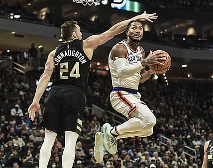 Nov 5, 2021; Milwaukee, Wisconsin, USA; New York Knicks guard Derrick Rose (4) takes a shot against Milwaukee Bucks guard Pat Connaughton (24) in the second quarter at Fiserv Forum. Mandatory Credit: Benny Sieu-USA TODAY Sports