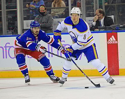 Nov 21, 2021; New York, New York, USA; New York Rangers left wing Chris Kreider (20) and Buffalo Sabres defenseman Robert Hagg (8) battle for the puck during the first period at Madison Square Garden. Mandatory Credit: Danny Wild-USA TODAY Sports