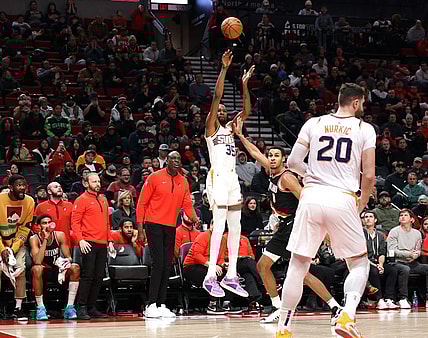 Jan 14, 2024; Portland, Oregon, USA; Phoenix Suns forward Kevin Durant (35) shoots a three-point shot over Portland Trail Blazers forward Kris Murray (8) as Phoenix Suns center Jusuf Nurkic (20) looks on in the fourth quarter at Moda Center. Mandatory Credit: Jaime Valdez-USA TODAY Sports