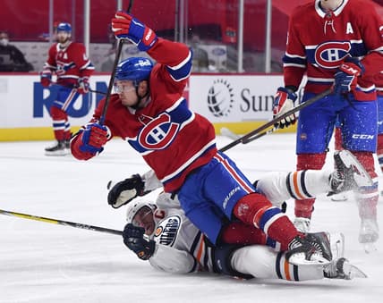May 10, 2021; Montreal, Quebec, CAN;Montreal Canadiens forward Artturi Lehkonen (62) trips over Edmonton Oilers forward Connor McDavid (97) during the first period at the Bell Centre. Mandatory Credit: Eric Bolte-USA TODAY Sports
