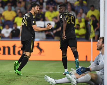 Jul 17, 2022; Nashville, Tennessee, USA; Los Angeles FC midfielder Ryan Hollingshead (24) and midfielder Daniel Crisostomo (20) celebrate after a goal past Nashville SC goalkeeper Joe Willis (1) during the second half at Geodis Park. Mandatory Credit: Christopher Hanewinckel-USA TODAY Sports