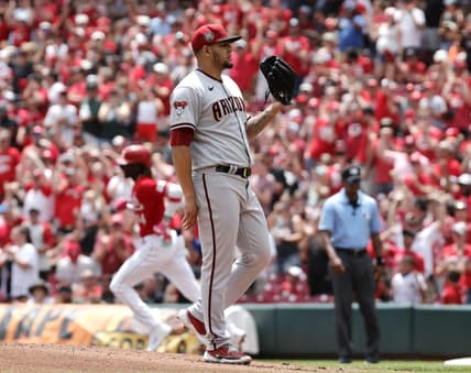Jul 23, 2023; Cincinnati, Ohio, USA; Arizona Diamondbacks relief pitcher Jose Ruiz (right) waits for a new ball after Cincinnati Reds third baseman Elly De La Cruz (left) runs the bases after hitting a solo home during the first inning at Great American Ball Park. Mandatory Credit: David Kohl-USA TODAY Sports