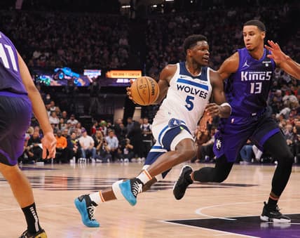 Dec 23, 2023; Sacramento, California, USA; Minnesota Timberwolves guard Anthony Edwards (5) drives in against Sacramento Kings forward Keegan Murray (13) during the first quarter at Golden 1 Center. Mandatory Credit: Kelley L Cox-USA TODAY Sports