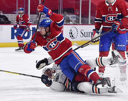 May 10, 2021; Montreal, Quebec, CAN;Montreal Canadiens forward Artturi Lehkonen (62) trips over Edmonton Oilers forward Connor McDavid (97) during the first period at the Bell Centre. Mandatory Credit: Eric Bolte-USA TODAY Sports