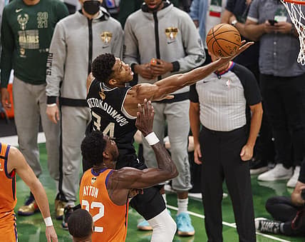 Jul 20, 2021; Milwaukee, Wisconsin, USA; Milwaukee Bucks forward Giannis Antetokounmpo (34) shoots over Phoenix Suns center Deandre Ayton (22) during the third quarter during game six of the 2021 NBA Finals at Fiserv Forum. Mandatory Credit: Jeff Hanisch-USA TODAY Sports