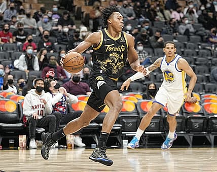 Dec 18, 2021; Toronto, Ontario, CAN; Toronto Raptors forward Scottie Barnes (4) dribbles the ball against Golden State Warriors forward Juan Toscano-Anderson (95) during the second half at Scotiabank Arena. Mandatory Credit: John E. Sokolowski-USA TODAY Sports
