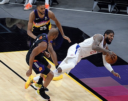 Apr 28, 2021; Phoenix, Arizona, USA; Phoenix Suns guard Chris Paul (3) fouls LA Clippers guard Paul George (13) during the second half at Phoenix Suns Arena. Mandatory Credit: Joe Camporeale-USA TODAY Sports