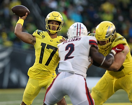 Oregon's Ty Thompson, left, throws down field against Stony Brook during the third quarter.

Eug 091821 Oregonfb 14