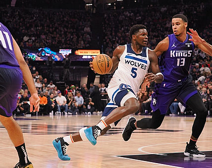 Dec 23, 2023; Sacramento, California, USA; Minnesota Timberwolves guard Anthony Edwards (5) drives in against Sacramento Kings forward Keegan Murray (13) during the first quarter at Golden 1 Center. Mandatory Credit: Kelley L Cox-USA TODAY Sports