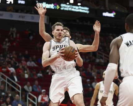 Jan 25, 2022; Houston, Texas, USA; San Antonio Spurs center Jakob Poeltl (25) secures a rebound away from Houston Rockets center Alperen Sengun (28) during the second quarter at Toyota Center. Mandatory Credit: Troy Taormina-USA TODAY Sports