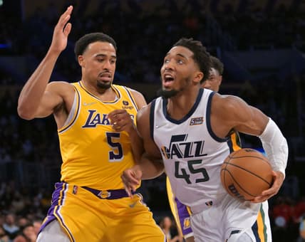 Jan 17, 2022; Los Angeles, California, USA; Los Angeles Lakers guard Talen Horton-Tucker (5) defends Utah Jazz guard Donovan Mitchell (45) in the second half at Crypto.com Arena. Mandatory Credit: Jayne Kamin-Oncea-USA TODAY Sports