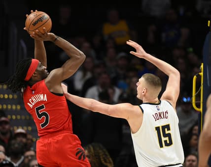 Mar 12, 2022; Denver, Colorado, USA;  Denver Nuggets center Nikola Jokic (15) puts his hand on the chest of Toronto Raptors forward Precious Achiuwa (5) as he takes a shot during the first quarter at Ball Arena. Mandatory Credit: John Leyba-USA TODAY Sports