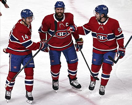 Apr 3, 2021; Montreal, Quebec, CAN; Montreal Canadiens center Nick Suzuki (14) and defenseman Shea Weber (6) and left wing Jonathan Drouin (92) celebrate after goal by right wing Tyler Toffoli (not pictured) against the Ottawa Senators during the first period at Bell Centre. Mandatory Credit: Jean-Yves Ahern-USA TODAY Sports