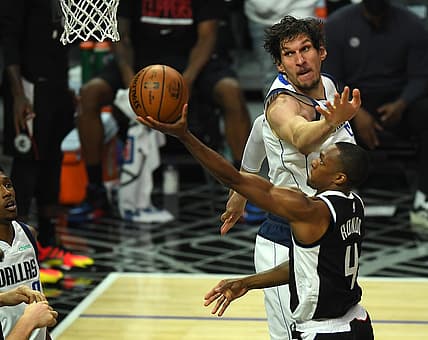 Jun 2, 2021; Los Angeles, California, USA;   Los Angeles Clippers guard Rajon Rondo (4) drives to the basket past Dallas Mavericks center Boban Marjanovic (51) in the first half of the game of round one of the 2021 NBA Playoffs at Staples Center. Mandatory Credit: Jayne Kamin-Oncea-USA TODAY Sports