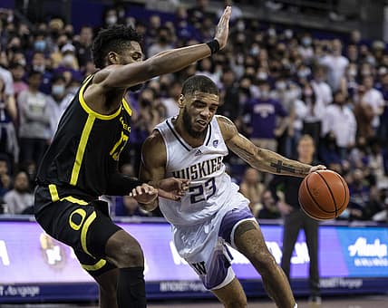 Mar 3, 2022; Seattle, Washington, USA; Washington Huskies guard Terrell Brown Jr. (23) drives against Oregon Ducks forward Quincy Guerrier (13) during the second half at Alaska Airlines Arena at Hec Edmundson Pavilion. Mandatory Credit: Stephen Brashear-USA TODAY Sports