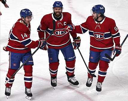 Apr 3, 2021; Montreal, Quebec, CAN; Montreal Canadiens center Nick Suzuki (14) and defenseman Shea Weber (6) and left wing Jonathan Drouin (92) celebrate after goal by right wing Tyler Toffoli (not pictured) against the Ottawa Senators during the first period at Bell Centre. Mandatory Credit: Jean-Yves Ahern-USA TODAY Sports