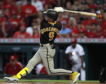 Jun 29, 2021; Cincinnati, Ohio, USA; San Diego Padres second baseman Jake Cronenworth (9) hits an RBI triple against the Cincinnati Reds during the first inning at Great American Ball Park. Mandatory Credit: David Kohl-USA TODAY Sports