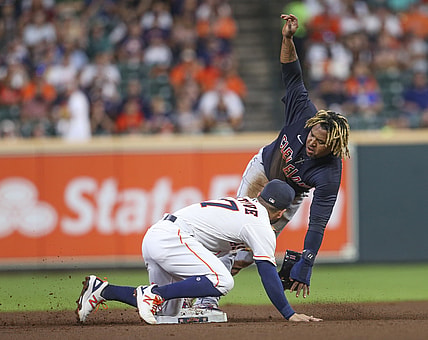 Jul 19, 2021; Houston, Texas, USA; Cleveland Indians third baseman Jose Ramirez (11) steals second base as Houston Astros second baseman Jose Altuve (27) applies the tag in the first inning Minute Maid Park. Mandatory Credit: Thomas Shea-USA TODAY Sports