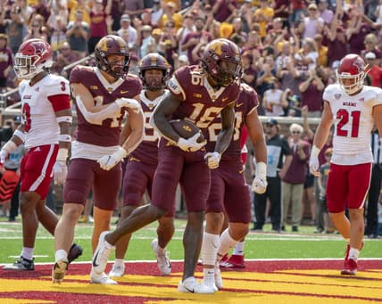 Sep 11, 2021; Minneapolis, Minnesota, USA; Minnesota Golden Gophers wide receiver Dylan Wright (16) scores in the second quarter, congratulated by teammates wide receiver Brady Boyd (14), wide receiver Daniel Jackson (9) and Minnesota Golden Gophers running back Bryce Williams (21) at Huntington Bank Stadium. Mandatory Credit: Matt Blewett-USA TODAY Sports