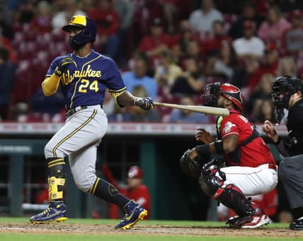 Sep 23, 2022; Cincinnati, Ohio, USA; Milwaukee Brewers designated hitter Andrew McCutchen (24) hits a two-RBI double against the Cincinnati Reds during the seventh inning at Great American Ball Park. Mandatory Credit: David Kohl-USA TODAY Sports
