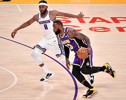 Apr 30, 2021; Los Angeles, California, USA; Los Angeles Lakers forward LeBron James (23) dribbles past Sacramento Kings forward Maurice Harkless (8) during the first quarter at Staples Center. James returned to the Lakers lineup after recovering from an ankle injury. Mandatory Credit: Robert Hanashiro-USA TODAY Sports