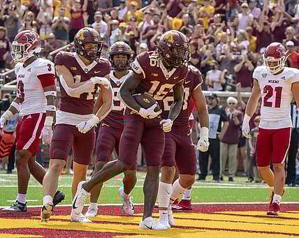 Sep 11, 2021; Minneapolis, Minnesota, USA; Minnesota Golden Gophers wide receiver Dylan Wright (16) scores in the second quarter, congratulated by teammates wide receiver Brady Boyd (14), wide receiver Daniel Jackson (9) and Minnesota Golden Gophers running back Bryce Williams (21) at Huntington Bank Stadium. Mandatory Credit: Matt Blewett-USA TODAY Sports