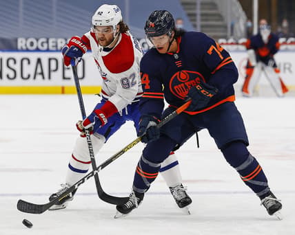 Apr 21, 2021; Edmonton, Alberta, CAN; Edmonton Oilersdefensemen Ethan Bear (74) and Montreal Canadiens forward Jonathan Drouin (92) battle for a loose puck during the first period at Rogers Place. Mandatory Credit: Perry Nelson-USA TODAY Sports