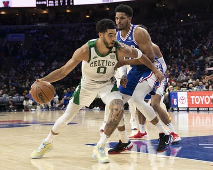 Jan 14, 2022; Philadelphia, Pennsylvania, USA;  Boston Celtics small forward Jayson Tatum (0) dribbles the ball against Philadelphia 76ers center Joel Embiid (21) defending during the second half at Wells Fargo Center. Mandatory Credit: Gregory Fisher-USA TODAY Sports