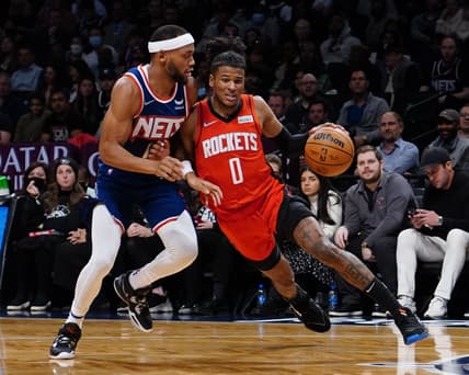 Apr 5, 2022; Brooklyn, New York, USA; Houston Rockets shooting guard Jalen Green (0) dribbles the ball against Brooklyn Nets small forward Bruce Brown (1) during the first half of the game at Barclays Center. Mandatory Credit: Gregory Fisher-USA TODAY Sports