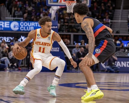 Oct 26, 2022; Detroit, Michigan, USA; Atlanta Hawks guard Trae Young (11) moves the ball up court against Detroit Pistons guard Killian Hayes (7) during the first half at Little Caesars Arena. Mandatory Credit: David Reginek-USA TODAY Sports