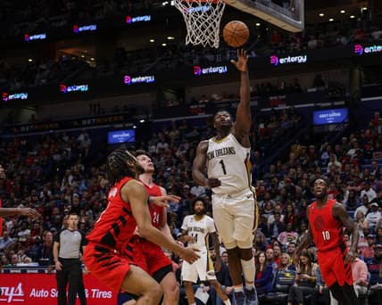 Nov 10, 2022; New Orleans, Louisiana, USA; New Orleans Pelicans forward Zion Williamson (1) drives to the basket against Portland Trail Blazers forward Drew Eubanks (24) and forward Trendon Watford (2) during the second half at Smoothie King Center. Mandatory Credit: Stephen Lew-USA TODAY Sports