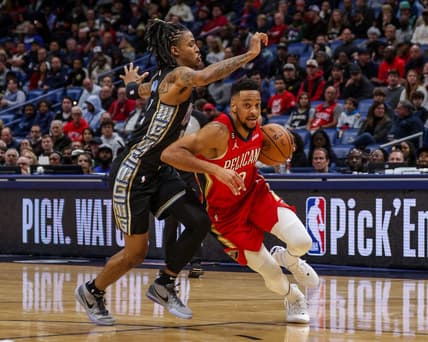 Nov 15, 2022; New Orleans, Louisiana, USA; New Orleans Pelicans guard CJ McCollum (3) drives to the basket against Memphis Grizzlies guard Ja Morant (12) during the first half at Smoothie King Center. Mandatory Credit: Stephen Lew-USA TODAY Sports