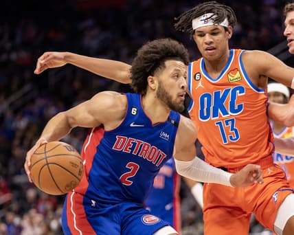 Nov 7, 2022; Detroit, Michigan, USA; Oklahoma City Thunder forward Ousmane Dieng (13) defends against Detroit Pistons guard Cade Cunningham (2) during the second half at Little Caesars Arena. Mandatory Credit: David Reginek-USA TODAY Sports