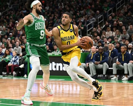Dec 21, 2022; Boston, Massachusetts, USA; Indiana Pacers guard Tyrese Haliburton (0) drives to the basket against Boston Celtics guard Derrick White (9) during the first quarter at the TD Garden. Mandatory Credit: Brian Fluharty-USA TODAY Sports