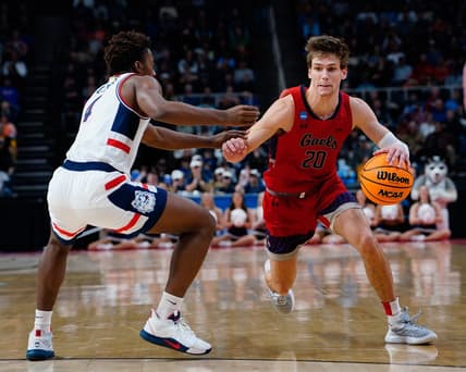 Mar 19, 2023; Albany, NY, USA; Saint Mary's Gaels guard Aidan Mahaney (20) dribbles the ball against Connecticut Huskies guard Nahiem Alleyne (4) during the second half at MVP Arena. Mandatory Credit: Gregory Fisher-USA TODAY Sports
