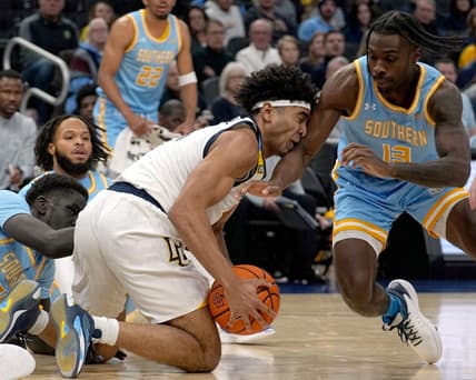 Nov 28, 2023; Milwaukee, Wisconsin, USA; Marquette Golden Eagles guard Stevie Mitchell (4) beats Southern Jaguars forward Delang Muon (35) and guard Dre'Shawn Allen (13) to a loose ball during the first half at Fiserv Forum. Mandatory Credit: Mark Hoffman-USA TODAY Sports